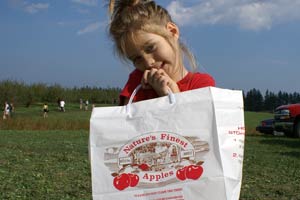 Child Holding Bag At Apple Orchard