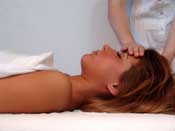 hand on womans forehead lying down