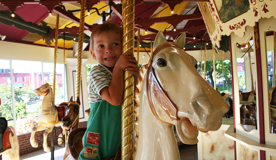 boy riding carousel