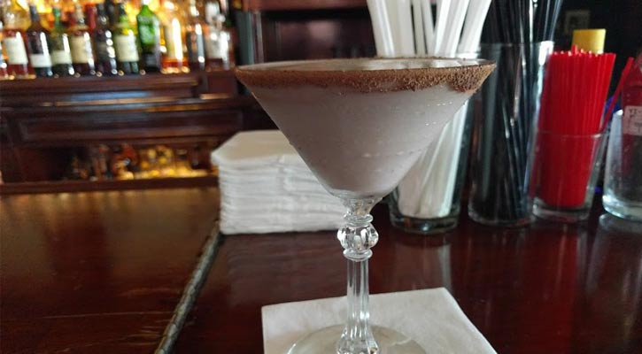 what looks like a chocolate martini on a bar