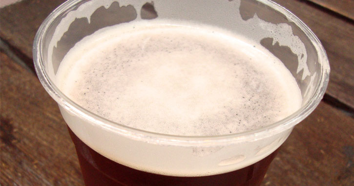 close up of a plastic cup of beer