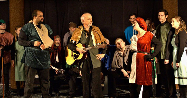 a large group of peole on stage in the middle of a production