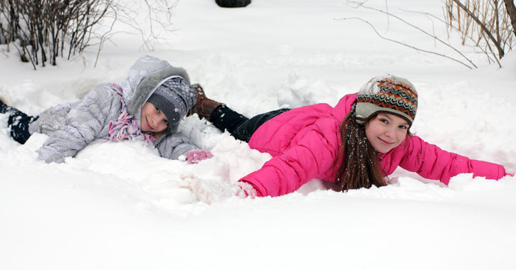 two kids playing in snow