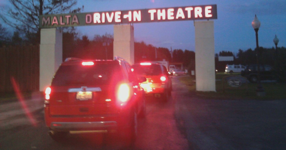 cars driving into a drive through theatre