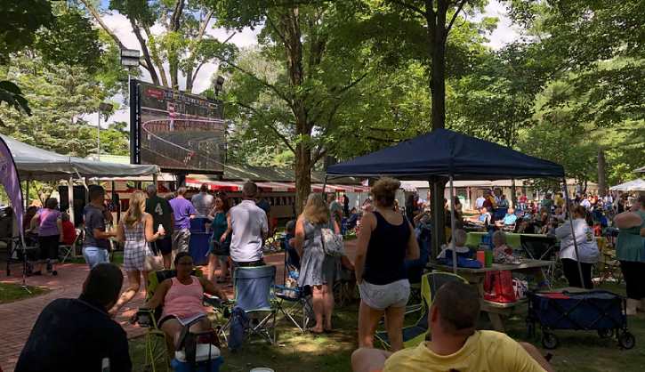 people watching races at backyard picnic tables