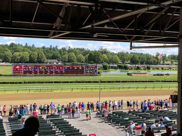 people standing trackside before a race