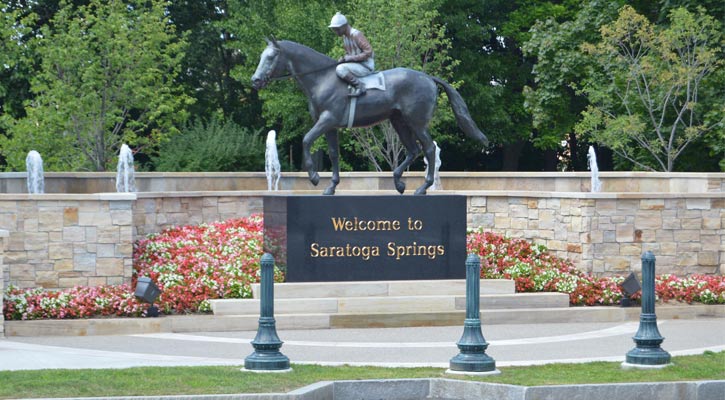 statue of a jockey that says Welcome to Saratoga under it