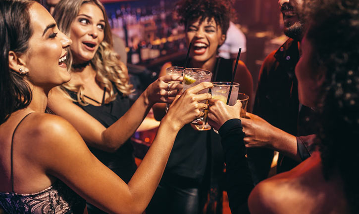 friends toasting drinks at a club