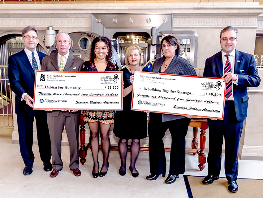 Members of the Saratoga Builders Association present checks to Rebuilding Together Saratoga County and Habitat for Humanity of Northern Saratoga, Warren and Washington Counties. Courtesy Showcase of Homes