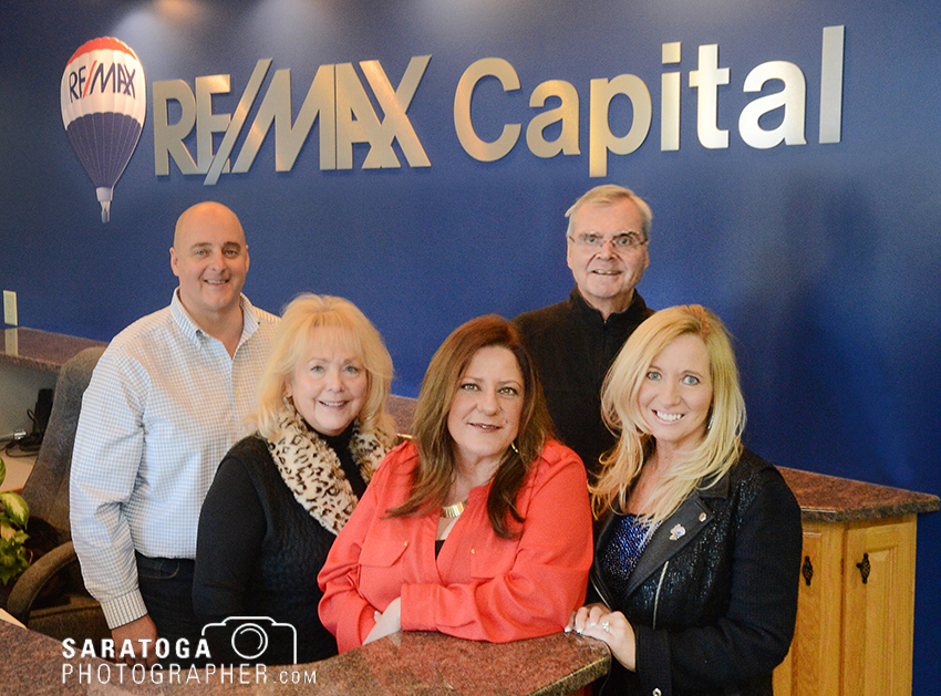 The staff of the RE/MAX Capital’s newest office in Clifton Park poses in the lobby. The company says the 3,000-square-foot office brings the RE/MAX brand to a growing community. ©2017 Saratoga Photographer.com