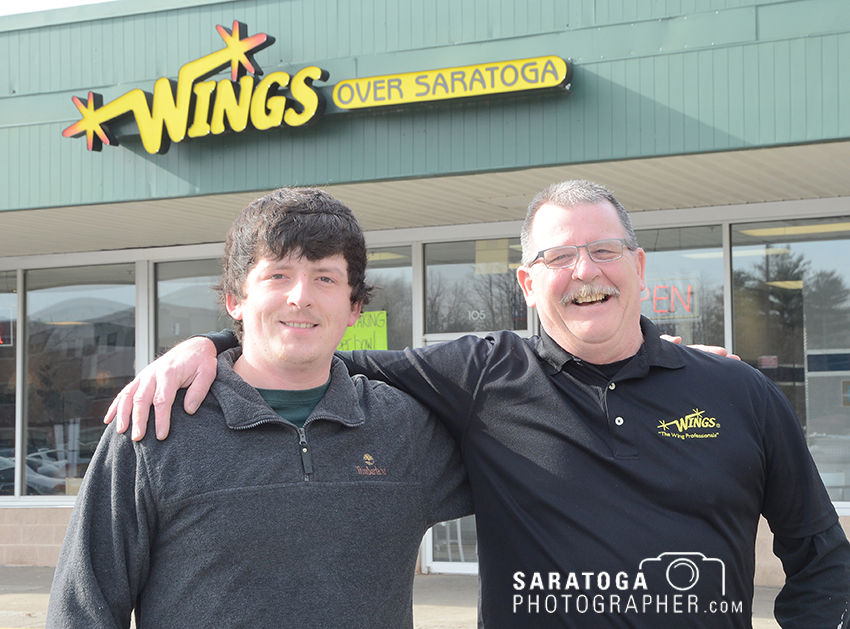 Joe Hill, right, and his son, Tanner, are owners of this store, Wings Over Saratoga, located at 103 West Ave. in Saratoga Springs. They serve a variety of foods for take-out or delivery. ©2017 Saratoga Photographer.com